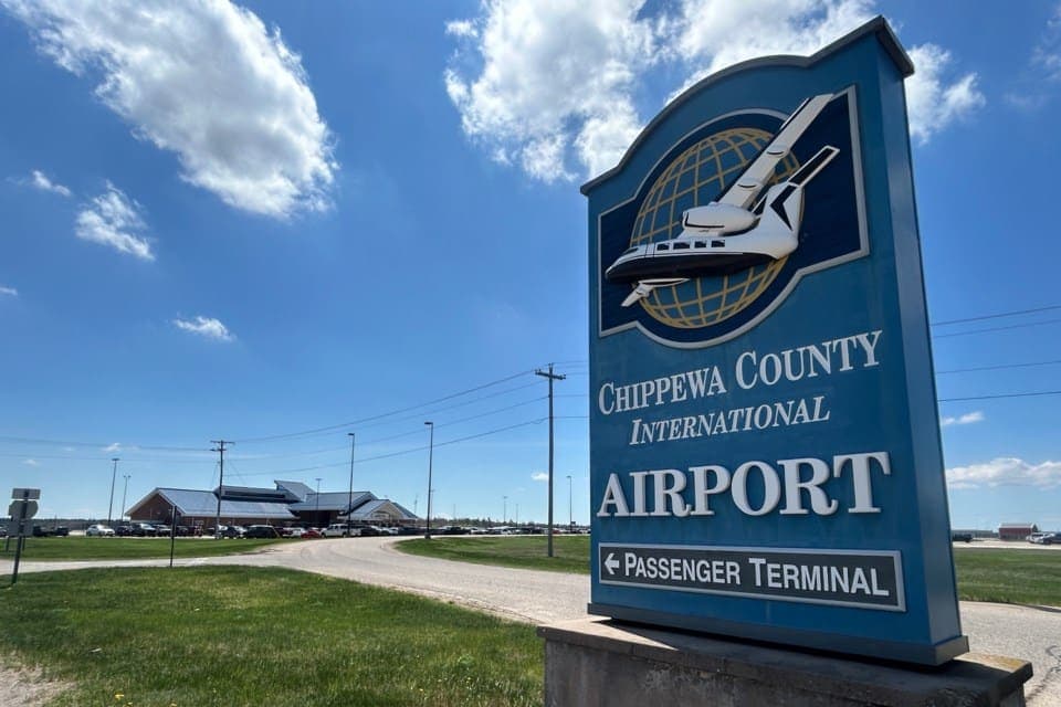 Airplane and terminal building at sunset at Chippewa County International Airport